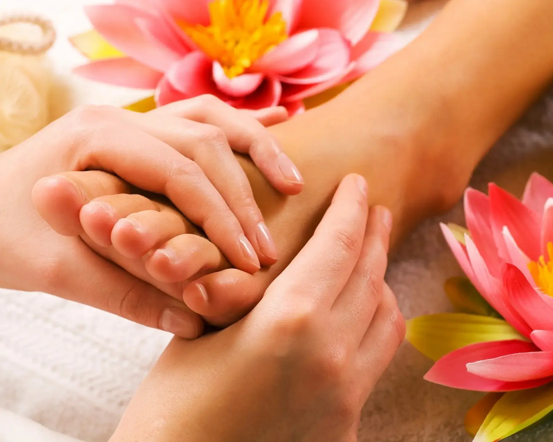 Hands massaging foot therapy session