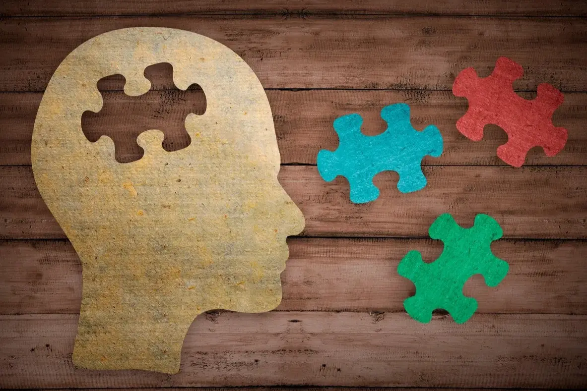 Wooden background with puzzle and head