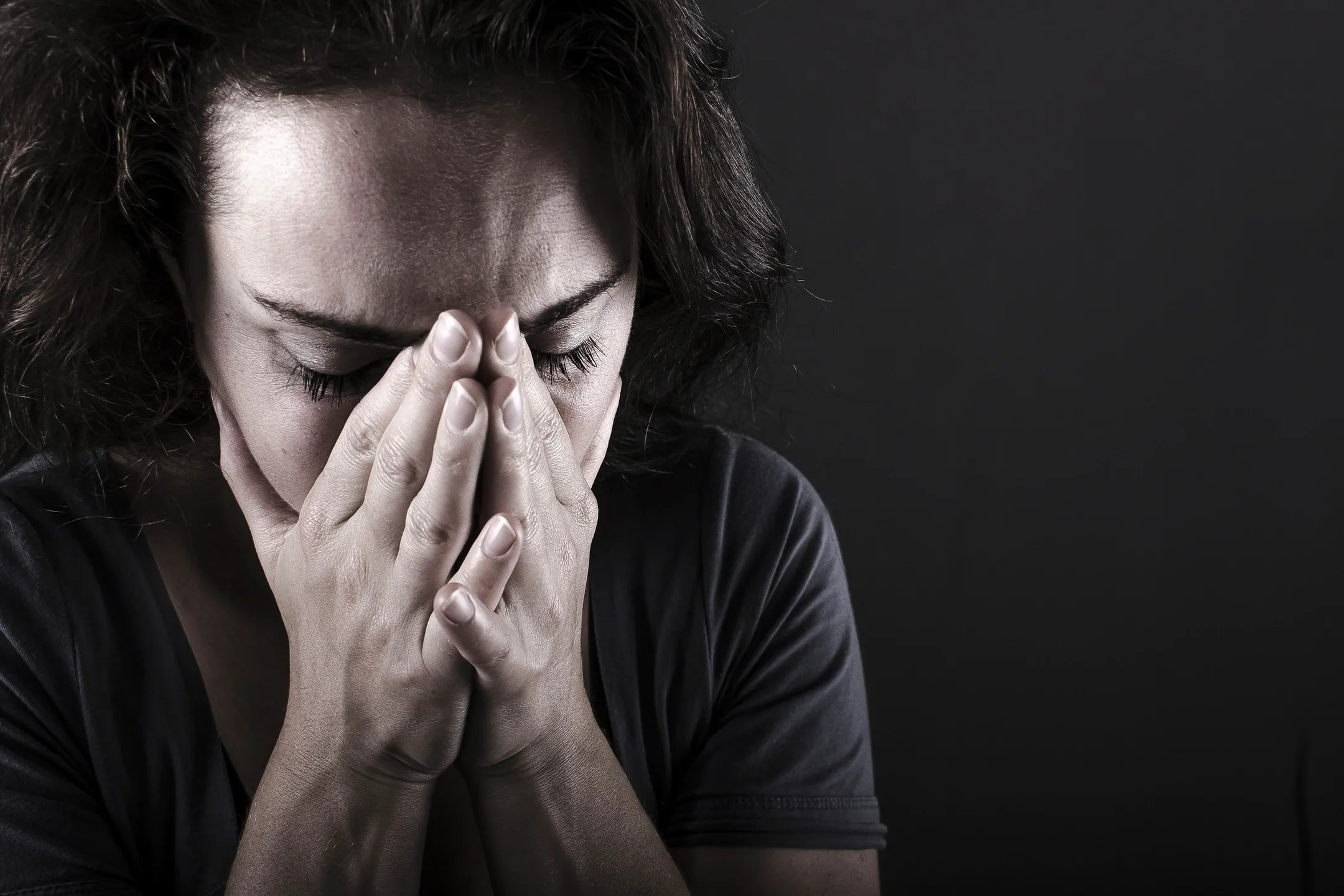 Woman covering face with hands