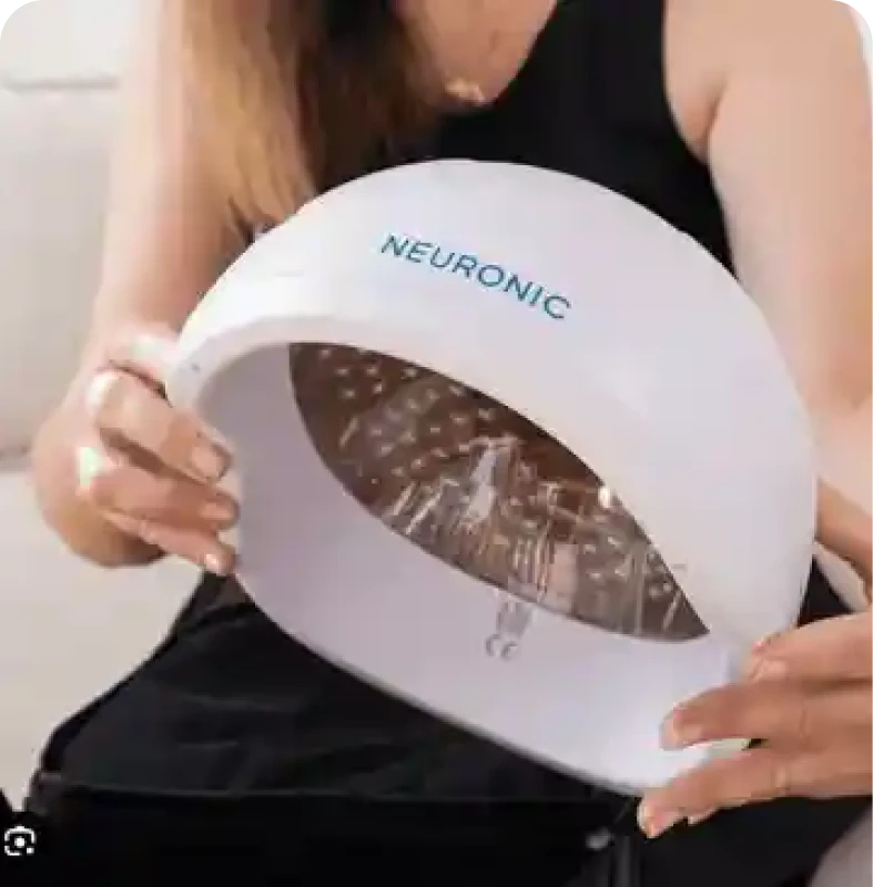 Hands holding LED hair treatment device